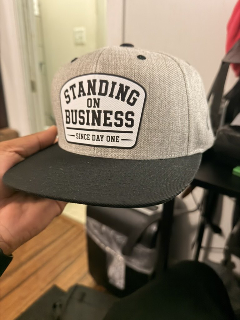 Gray and black custom hat with Standing On Business patch.